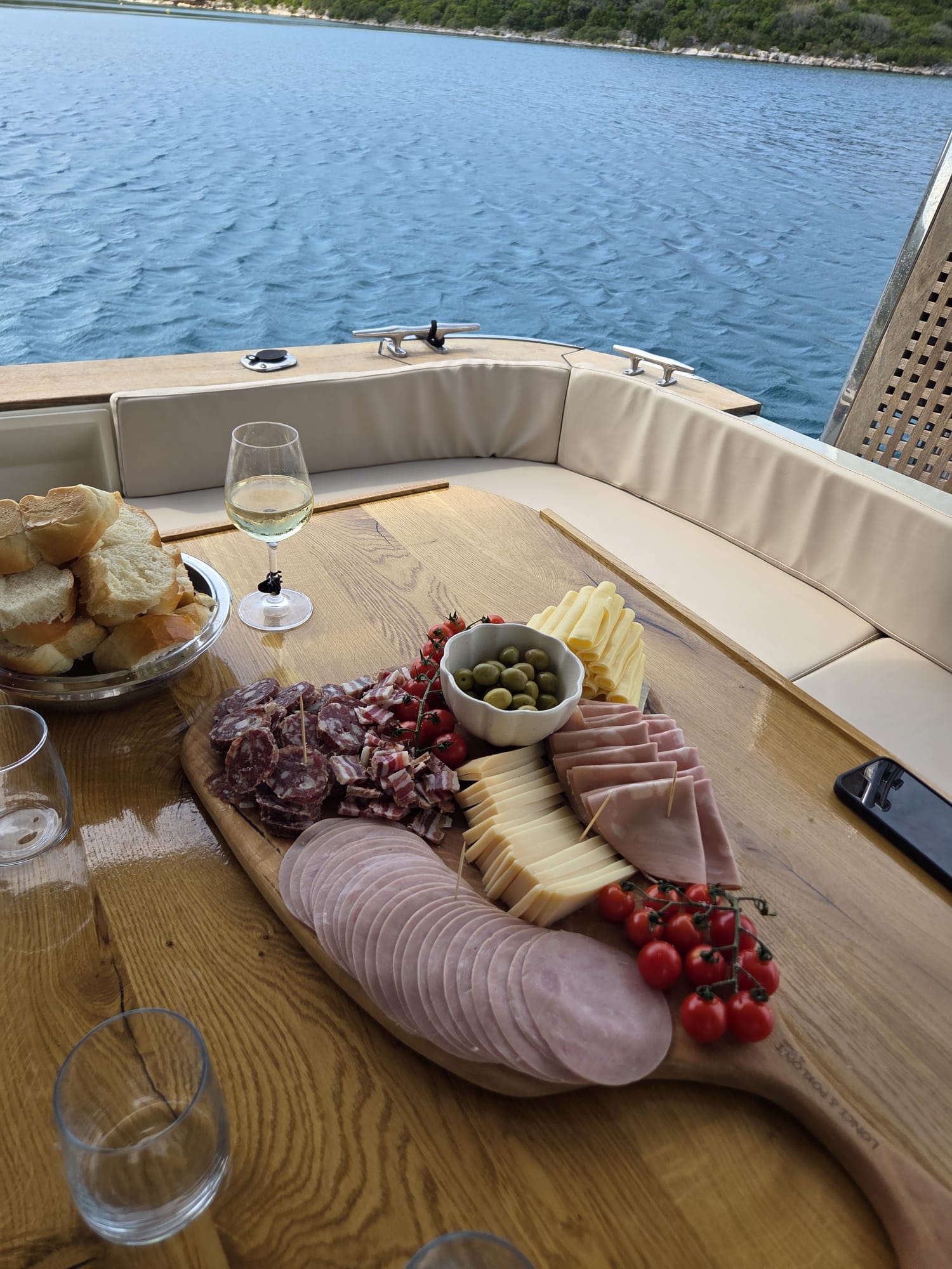 A wine and charcuterie platter served on deck overlooking the bay